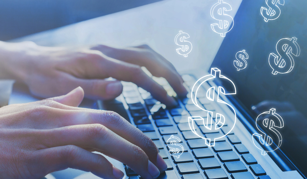 Year-End Close in Business Central Blog Image - hands on computer with dollar signs